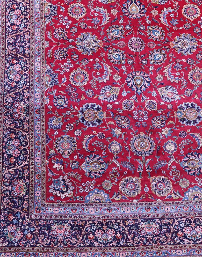 A Kashan burgundy ground carpet